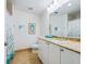 This bathroom features a long vanity with marble countertop and tiled floors at 6512 Midnight Pass Rd # 301, Sarasota, FL 34242