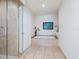 Bathroom featuring a tub with tile surround, a glass shower, and tiled floors at 6512 Midnight Pass Rd # 301, Sarasota, FL 34242