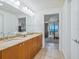 Bathroom featuring double sinks, granite countertops, and an ocean view at 6512 Midnight Pass Rd # 301, Sarasota, FL 34242