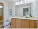 Bright bathroom features a spacious vanity, large mirror, and artwork on the wall at 6512 Midnight Pass Rd # 301, Sarasota, FL 34242