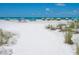 Wide sandy beach with plenty of umbrellas and seating at 6512 Midnight Pass Rd # 301, Sarasota, FL 34242