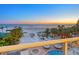 Beach view with palm trees, blue ocean, jacuzzi and lounge chairs at 6512 Midnight Pass Rd # 301, Sarasota, FL 34242