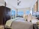 Bright bedroom featuring a dark wood canopy bed, rug, and beautiful ocean views at 6512 Midnight Pass Rd # 301, Sarasota, FL 34242