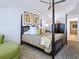 Lovely bedroom featuring a dark wood canopy bed, dresser, and accent pieces at 6512 Midnight Pass Rd # 301, Sarasota, FL 34242