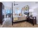 Beautiful primary bedroom with a dark wood canopy bed and stunning ocean views at 6512 Midnight Pass Rd # 301, Sarasota, FL 34242