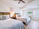 Comfortable bedroom with two beds, a ceiling fan, and tile floors at 6512 Midnight Pass Rd # 301, Sarasota, FL 34242