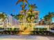 Beautiful building exterior with lush landscaping and palm trees, perfect for a relaxed lifestyle at 6512 Midnight Pass Rd # 301, Sarasota, FL 34242