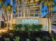 The illuminated 'Crescent' sign in landscaping welcomes you to this luxurious beach-front property at 6512 Midnight Pass Rd # 301, Sarasota, FL 34242