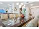 Bright dining room featuring a stylish glass-top table and unique modern chandelier at 6512 Midnight Pass Rd # 301, Sarasota, FL 34242