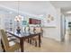 Bright dining area with a modern light fixture, open to the kitchen at 6512 Midnight Pass Rd # 301, Sarasota, FL 34242