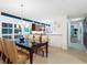 Bright dining room featuring modern light fixture, stylish table with seating for six, and sleek hardwood flooring at 6512 Midnight Pass Rd # 301, Sarasota, FL 34242