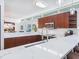 Modern kitchen with sleek white countertop and stainless steel appliances at 6512 Midnight Pass Rd # 301, Sarasota, FL 34242