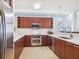 Modern kitchen features stainless appliances, dark wood cabinets and bright counters at 6512 Midnight Pass Rd # 301, Sarasota, FL 34242