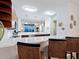 Beautiful kitchen boasting white quartz countertops, modern stainless steel appliances, and a breakfast bar with wicker stools at 6512 Midnight Pass Rd # 301, Sarasota, FL 34242