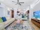 Bright, open living room featuring modern decor, a ceiling fan and sleek finishes at 6512 Midnight Pass Rd # 301, Sarasota, FL 34242