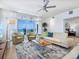 Bright and airy living room featuring comfortable seating, a modern ceiling fan, and ocean views at 6512 Midnight Pass Rd # 301, Sarasota, FL 34242