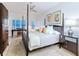 Tranquil primary bedroom with a king-sized bed, coastal views, and a cozy sitting area at 6512 Midnight Pass Rd # 301, Sarasota, FL 34242