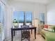 Office space featuring a desk, chair, couch, and stunning ocean views through shuttered windows at 6512 Midnight Pass Rd # 301, Sarasota, FL 34242