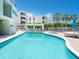 Community pool with plenty of seating and lush landscaping at 6512 Midnight Pass Rd # 301, Sarasota, FL 34242