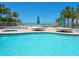 Relaxing pool area with nearby beach access and plenty of umbrellas at 6512 Midnight Pass Rd # 301, Sarasota, FL 34242