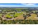 Wide aerial perspective of an estate with several ponds and structures set within a verdant environment at 7160 Myakka Valley Trl, Sarasota, FL 34241