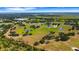Overhead shot of a sprawling property featuring multiple ponds and scattered residences in a green landscape at 7160 Myakka Valley Trl, Sarasota, FL 34241
