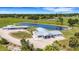 Birds-eye view of a property featuring buildings and pond, surrounded by trees and greenery at 7160 Myakka Valley Trl, Sarasota, FL 34241