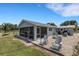 Spacious backyard with a screened-in patio, gravel area, and comfortable seating for outdoor enjoyment at 7160 Myakka Valley Trl, Sarasota, FL 34241