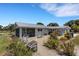 Picturesque backyard features a spacious patio, lush landscaping, and serene views of the surrounding countryside at 7160 Myakka Valley Trl, Sarasota, FL 34241