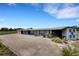 Large horse barn featuring multiple stalls, ample parking, and well-maintained grounds at 7160 Myakka Valley Trl, Sarasota, FL 34241