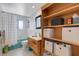 Cozy bathroom with a vanity and storage shelving, offering practical space and convenience at 7160 Myakka Valley Trl, Sarasota, FL 34241