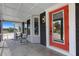 Charming entryway with a bright red door and black brick accents, creating a striking and welcoming facade at 7160 Myakka Valley Trl, Sarasota, FL 34241