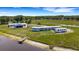 Aerial view of a rural home with a long garage, a pond, and an RV parked nearby at 7160 Myakka Valley Trl, Sarasota, FL 34241