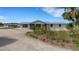 Lovely home featuring a metal roof, screened porch and mature landscaping at 7160 Myakka Valley Trl, Sarasota, FL 34241