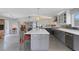 Large kitchen features center island and open concept layout to living area at 7160 Myakka Valley Trl, Sarasota, FL 34241