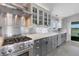 Modern kitchen with stainless appliances, neutral cabinets, and stone countertop at 7160 Myakka Valley Trl, Sarasota, FL 34241