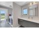 Bright laundry room with modern washer and dryer and a sink with stone countertops at 7160 Myakka Valley Trl, Sarasota, FL 34241