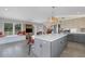 Open layout between the living area and kitchen, featuring an island at 7160 Myakka Valley Trl, Sarasota, FL 34241