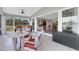 Inviting screened patio with comfortable seating, seamlessly connected to a stylish living room with abundant natural light at 7160 Myakka Valley Trl, Sarasota, FL 34241