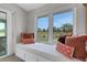 Cozy window seat with pillows overlooking the serene outdoor view at 7160 Myakka Valley Trl, Sarasota, FL 34241