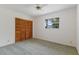 Bedroom with ample natural light, wooden closet, and a ceiling fan at 7803 2Nd W Ave, Bradenton, FL 34209