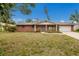 Charming single-story brick home with a well-maintained lawn and an attached two-car garage at 7803 2Nd W Ave, Bradenton, FL 34209
