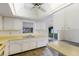 Sunny eat-in kitchen with white cabinets, neutral counters, and a window view to the outdoors at 7803 2Nd W Ave, Bradenton, FL 34209