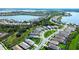 Expansive aerial view showcasing the community's lake and lush landscaping at 8077 Sandstar Way, Sarasota, FL 34240