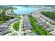 An aerial view showcases this community's beautiful lake and sprawling residences at 8077 Sandstar Way, Sarasota, FL 34240