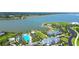 Aerial view showcases resort-style community amenities near a tranquil lake and surrounding neighborhood at 8077 Sandstar Way, Sarasota, FL 34240