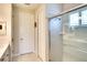 Bathroom featuring a glass enclosed shower with tile surround, complemented by a door to the water closet at 8077 Sandstar Way, Sarasota, FL 34240