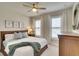 Well-lit bedroom with a comfortable bed, neutral decor, and soft carpet flooring at 8077 Sandstar Way, Sarasota, FL 34240