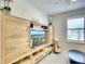 Multi-purpose room with a large entertainment center, guitar, and modern decor at 8077 Sandstar Way, Sarasota, FL 34240
