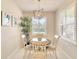 Charming dining nook featuring bright, shuttered windows and a quaint chandelier, perfect for cozy meals at 8077 Sandstar Way, Sarasota, FL 34240